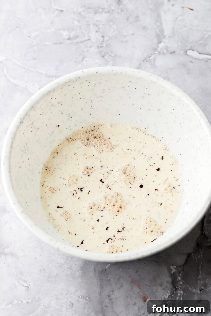 Decadent Chocolate Ganache Cake Recipe 6 Hot cream on top of chocolate in a bowl
