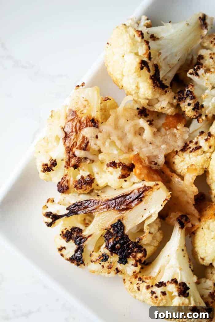 Crispy Keto Roasted Cauliflower with Parmesan 4 roasted keto cauliflower recipe served on white dish