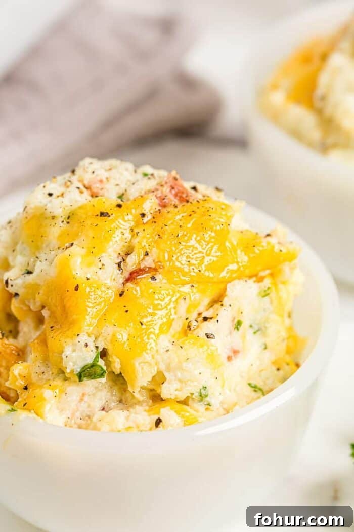 Crispy Keto Roasted Cauliflower with Parmesan 8 cheesy cauliflower casserole in a small dish with cheese on top