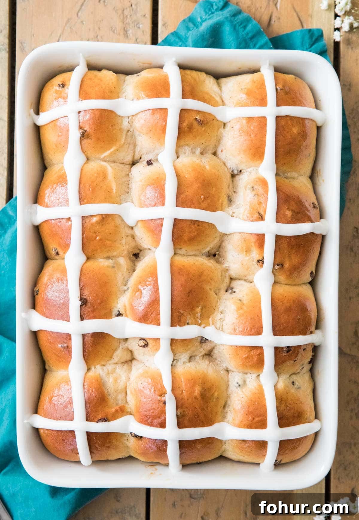 Hot Cross Buns Recipe for Easter Morning 4 Iced buns in a white baking dish.