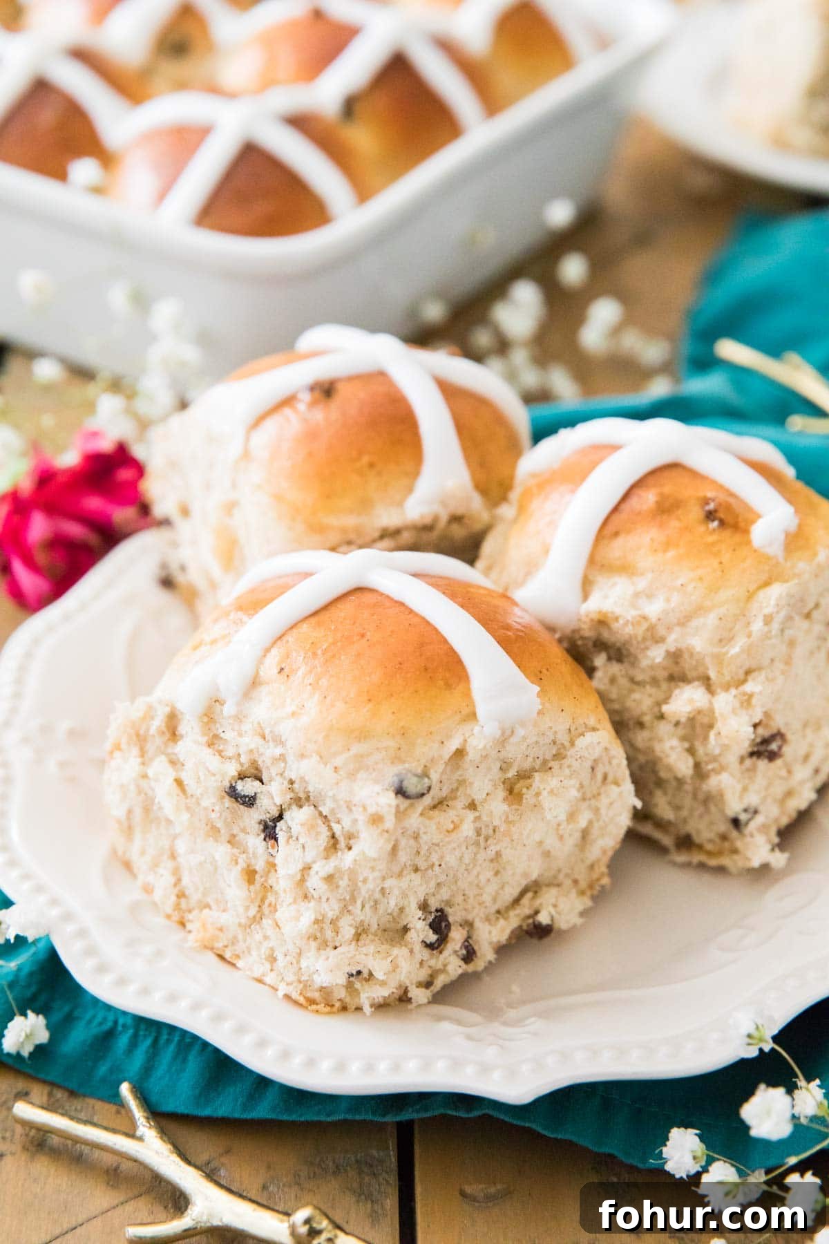 Hot Cross Buns Recipe for Easter Morning 5 Three iced buns on a white plate.