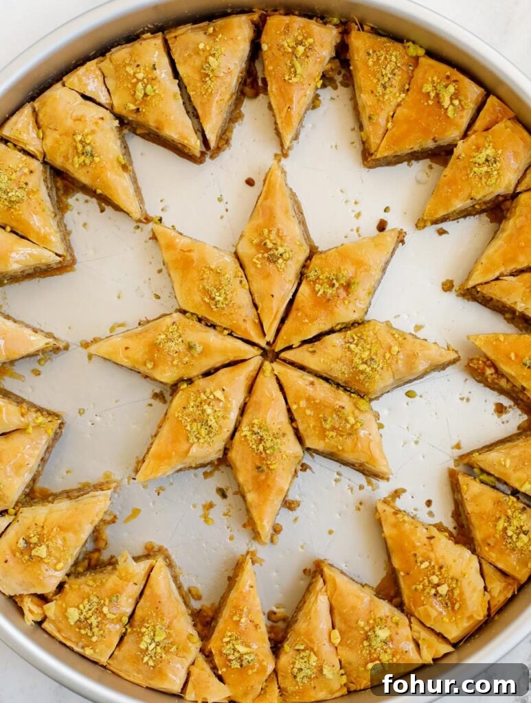 Homemade Walnut Baklava Recipe with Honey Syrup 2 Walnut baklava in a pan with pieces removed.