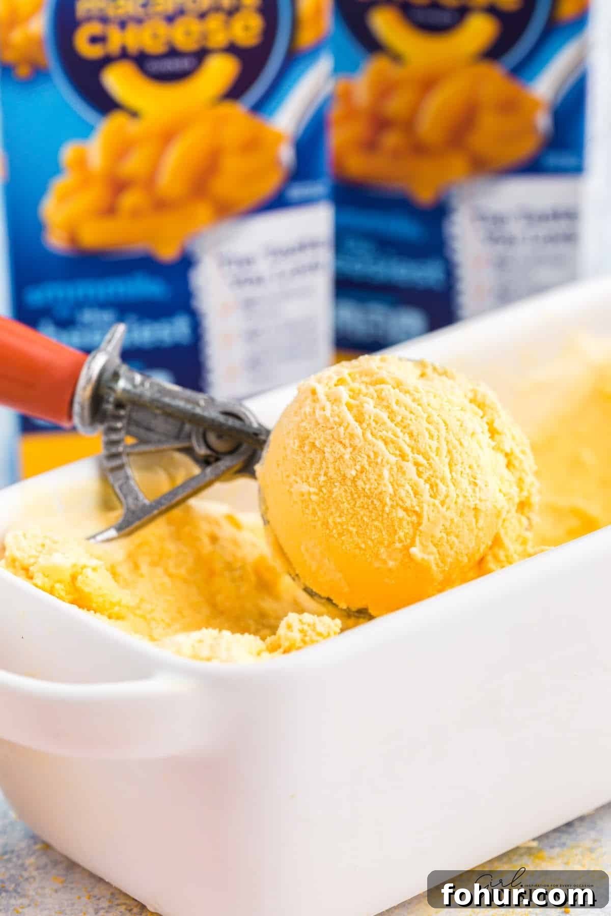 Copycat Mac and Cheese Ice Cream Recipe 11 Scooping the Mac and Cheese ice cream out of the bowl.
