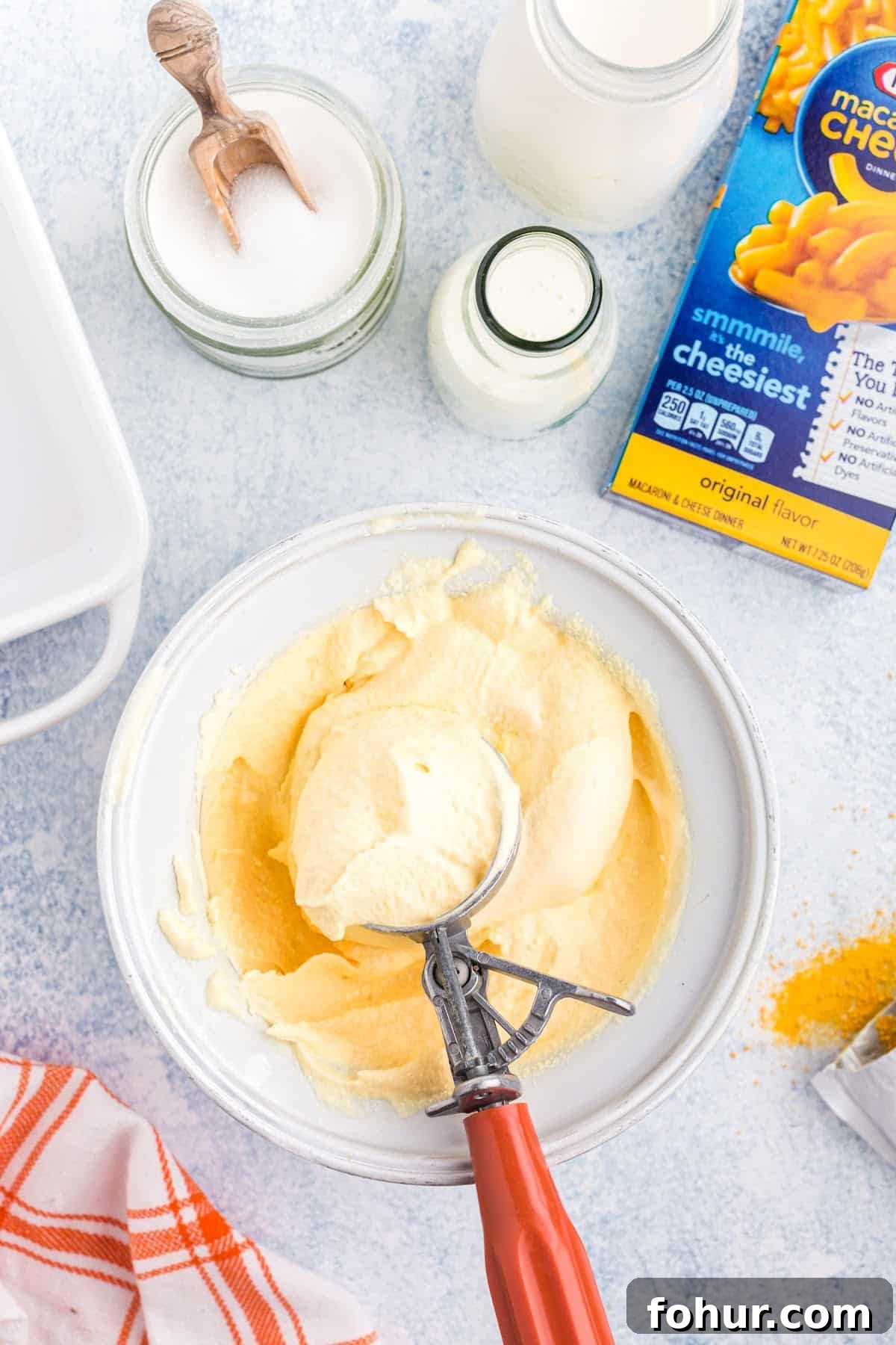 Copycat Mac and Cheese Ice Cream Recipe 8 Scooping the ice cream out of the bowl.