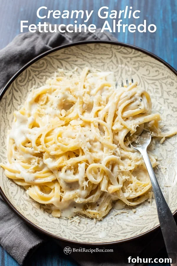 Easy Fettuccine Alfredo Recipe is the BEST vegetarian creamy garlic pasta recipe | BestRecipebox.com Easy Fettuccine Alfredo Recipe on plate with fork