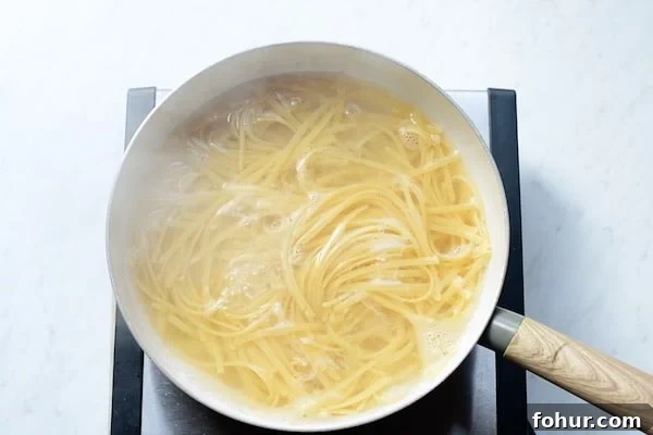 Creamy Fettuccine Alfredo: 30-Minute Vegetarian Recipe 2 Fettuccini pasta in boiling water