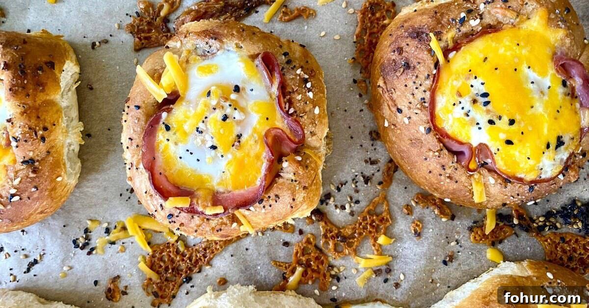 Baked Eggs in Mini Bread Rolls 4 bread bowls with ham and egg sandwiches.