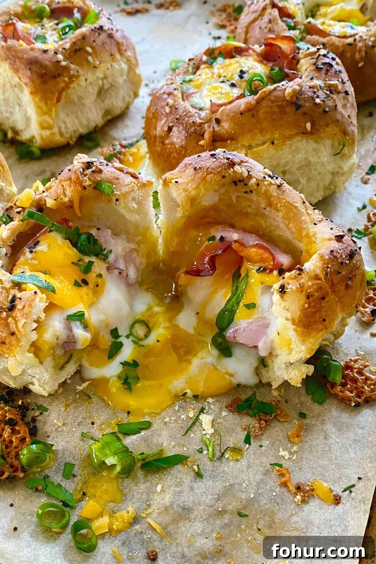 Baked Eggs in Mini Bread Rolls 7 a runny egg in a ham and cheese bread bowl.