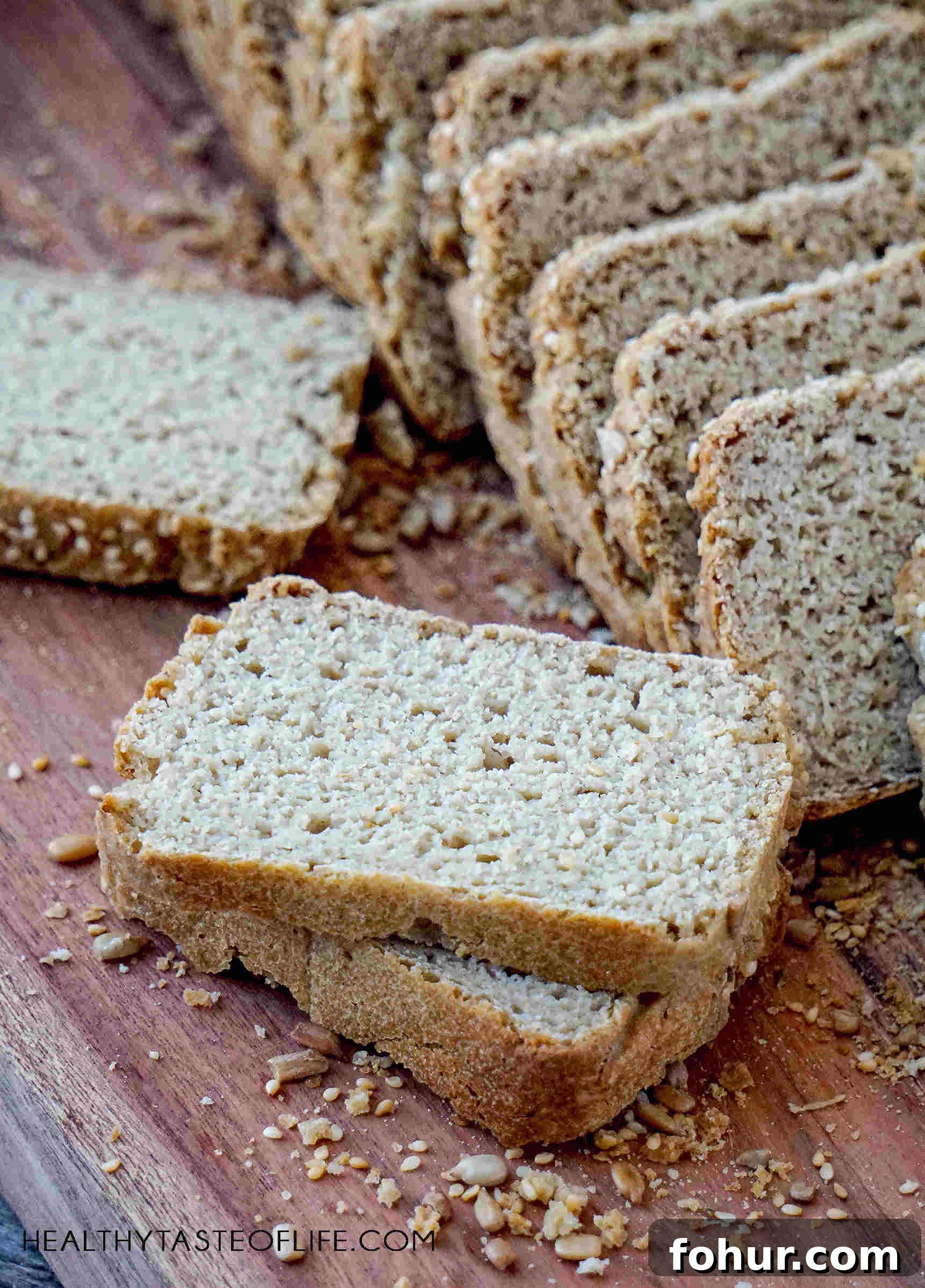 Gluten-Free Vegan Sourdough Bread, No Yeast or Xanthan Gum 4 Sliced Gluten Free Sourdough Bread on a wooden board, showing texture inside (Vegan Yeast Free recipe, no xanthan, no psyllium, healthier flours)