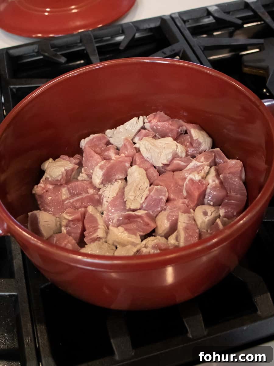 Classic Pork Stew Recipe: Tender Slow-Simmered Pork & Vegetables 4 Cooking the cut up pork in a pot.