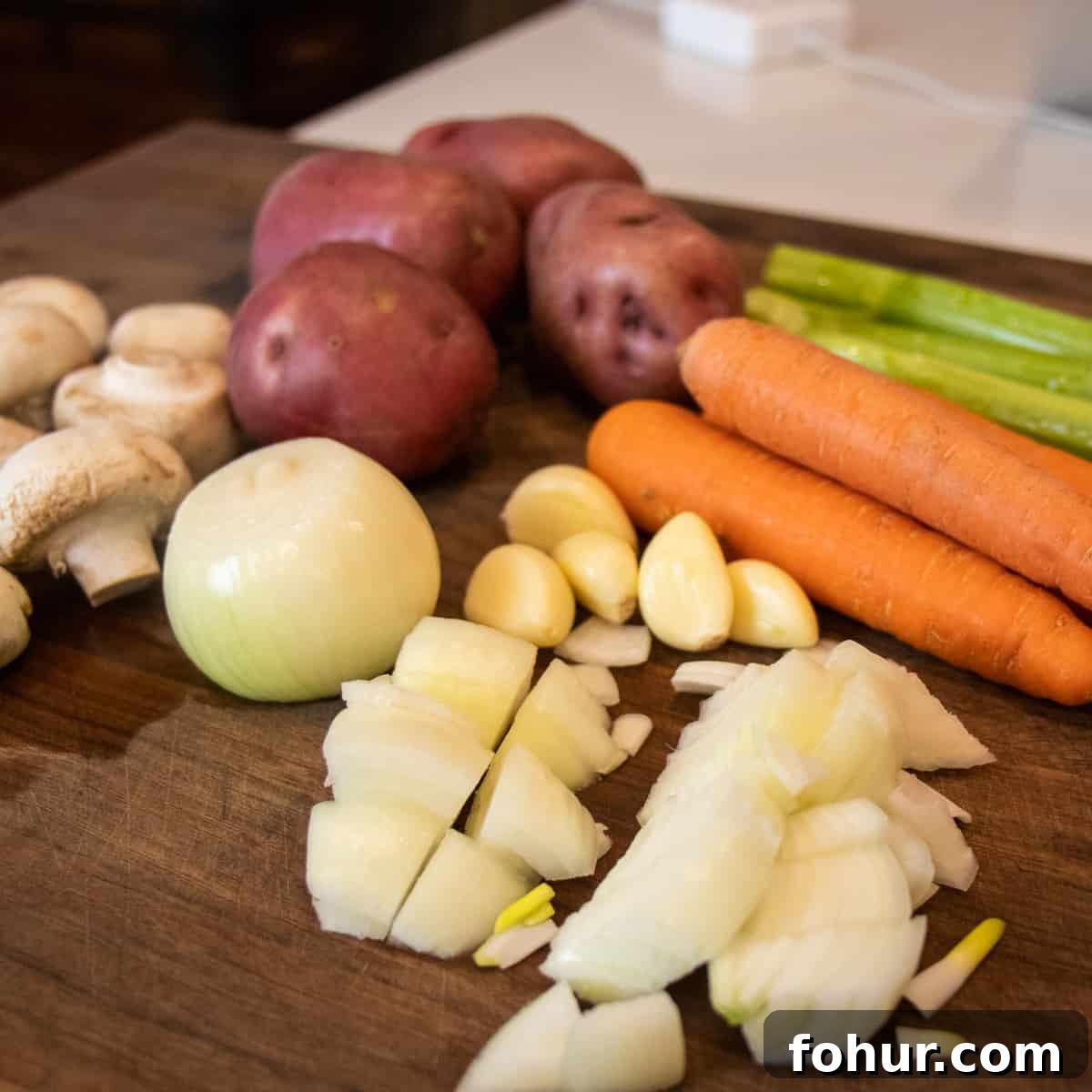 Classic Pork Stew Recipe: Tender Slow-Simmered Pork & Vegetables 5 Cutting board with cut up vegetables.