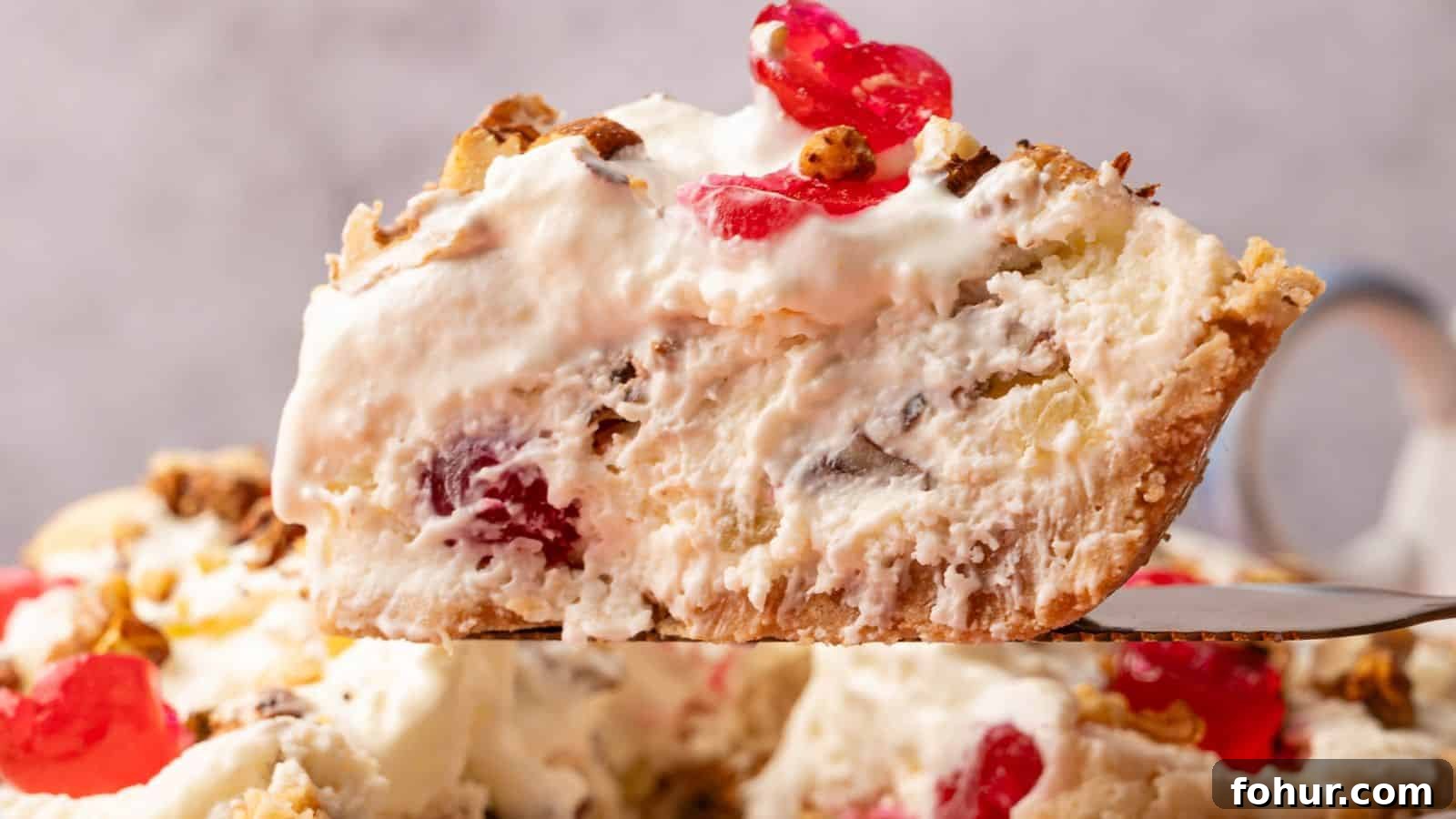 31 New Year's Eve Snacks for Late-Night Parties 17 A close-up of a slice of creamy pie with visible cherries, nuts, and a flaky crust, being lifted from the rest of the pie.