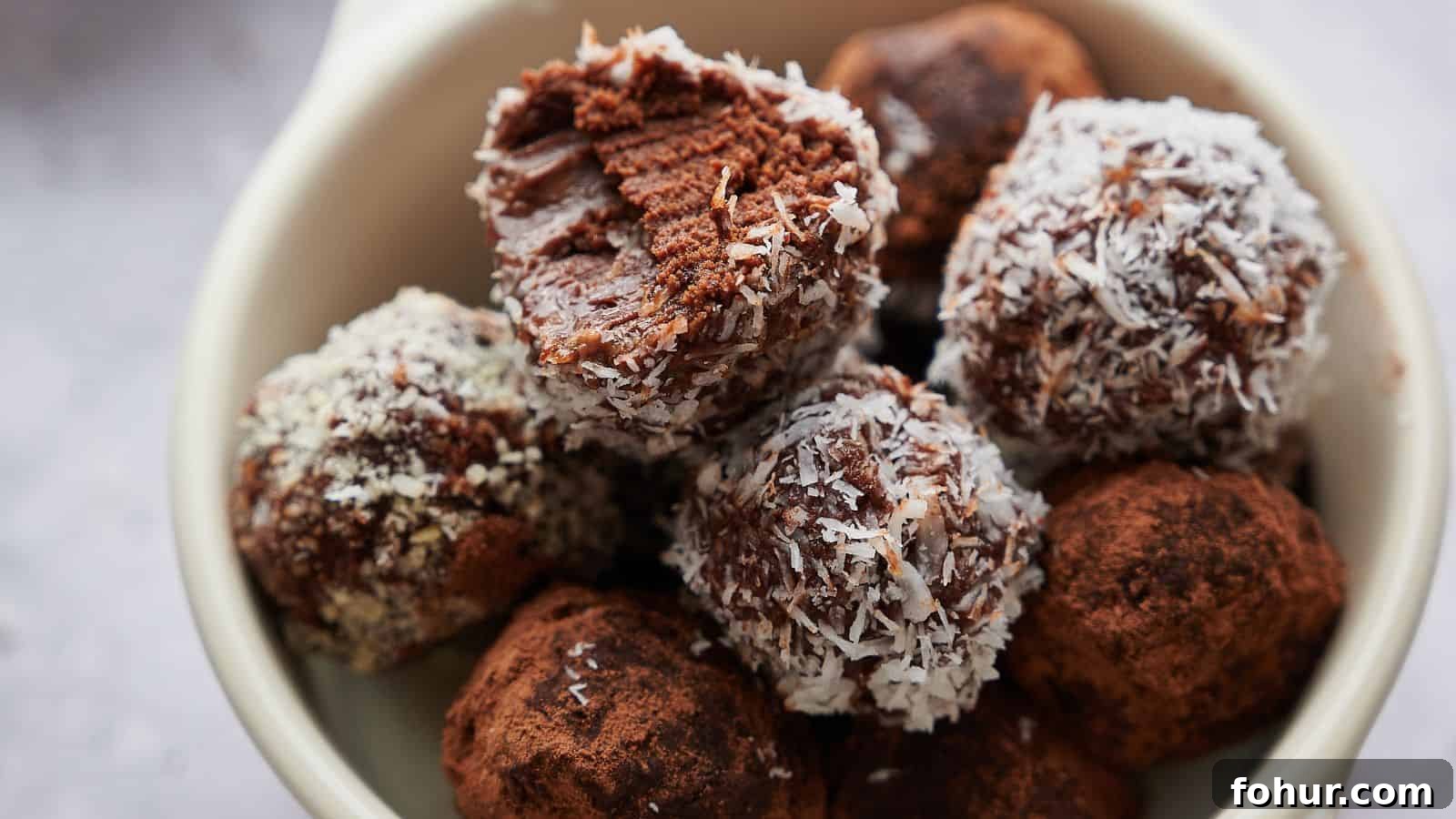31 New Year's Eve Snacks for Late-Night Parties 25 A bowl containing chocolate truffles, some coated with shredded coconut and others with cocoa powder; one truffle has a bite taken out of it.