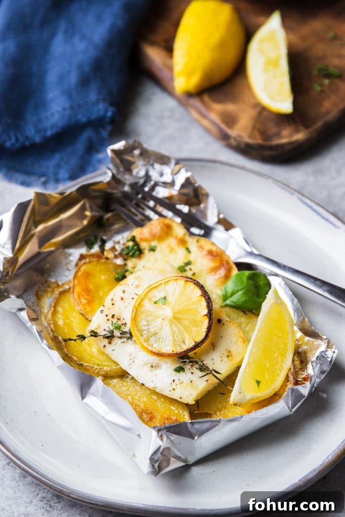 Lemon Herb Fish Baked in Foil with Potatoes 4 fish and potatoes baked in foil. A fish in foil packet on a plate with a fork