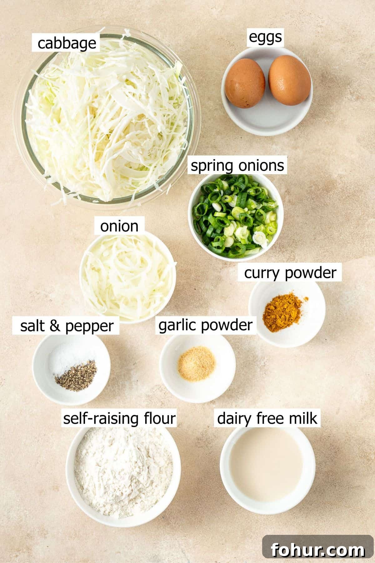 Crispy Cabbage Fritters Recipe with Tangy Yogurt Dip 2 All ingredients needed to make cabbage fritters laid out in small bowls.