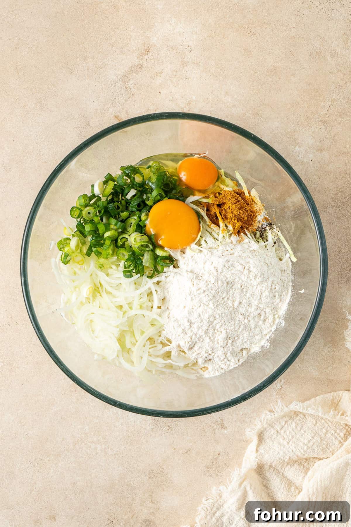Crispy Cabbage Fritters Recipe with Tangy Yogurt Dip 4 All ingredients for the cabbage fritters in a glass mixing bowl.