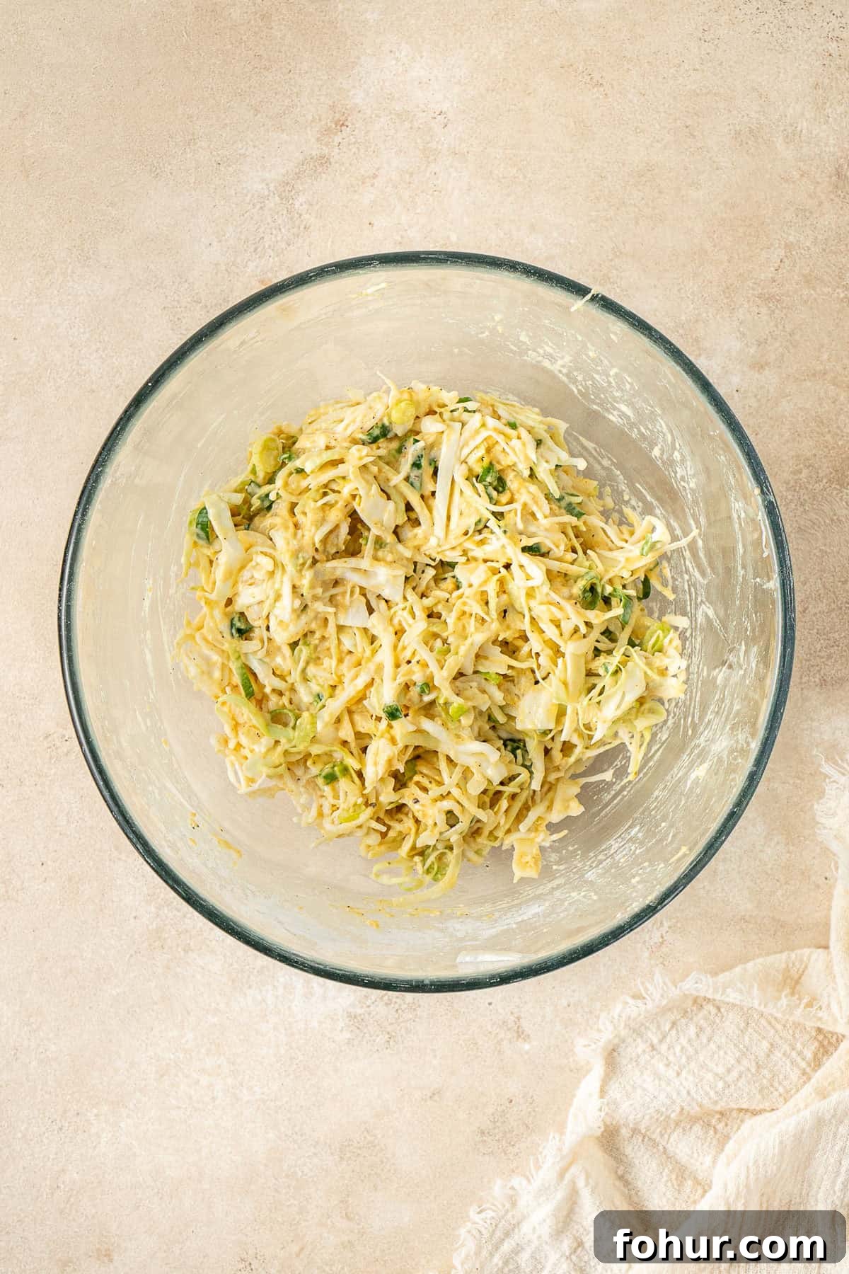 Crispy Cabbage Fritters Recipe with Tangy Yogurt Dip 5 The cabbage fritter batter in a glass mixing bowl.