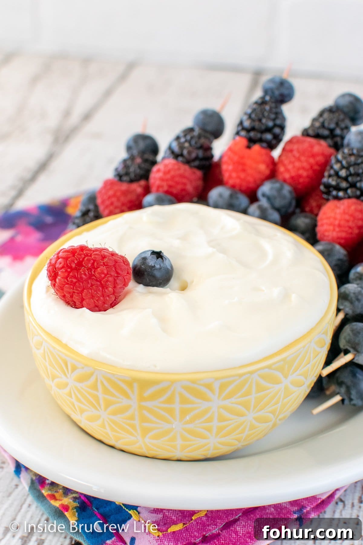 A bowl of lemon dip on a white plate.