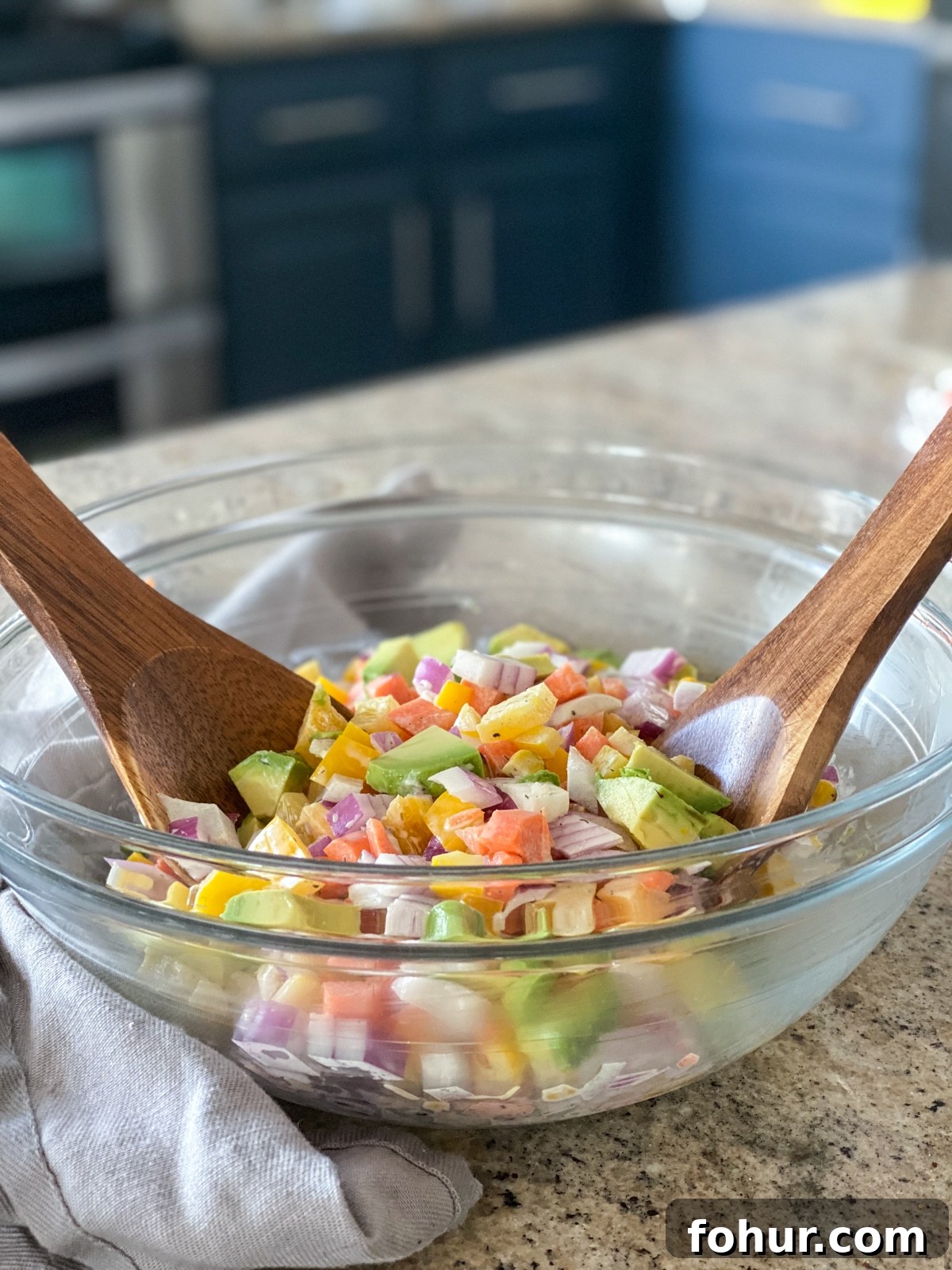 Salad being mixed with lime juice and ranch dressing