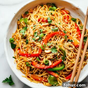 Easy 15-minute Asian-style noodles with vegetables in a white bowl.
