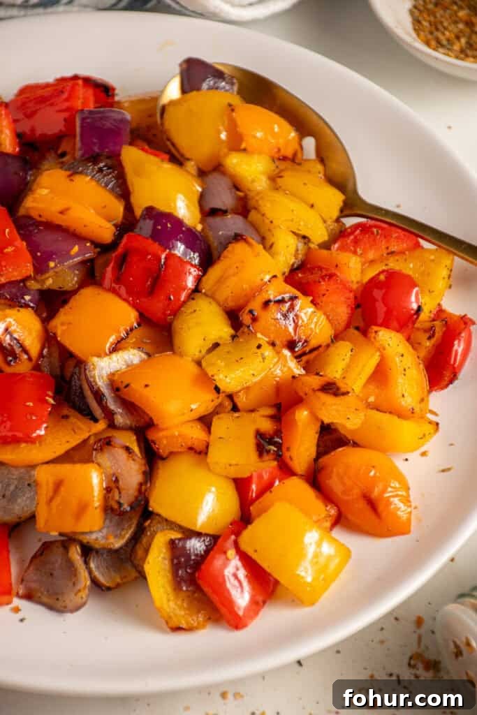 Grilled Peppers and Onions Recipe for Sides and Sandwiches 2 Colorful Grilled Peppers and Onions on a white plate.