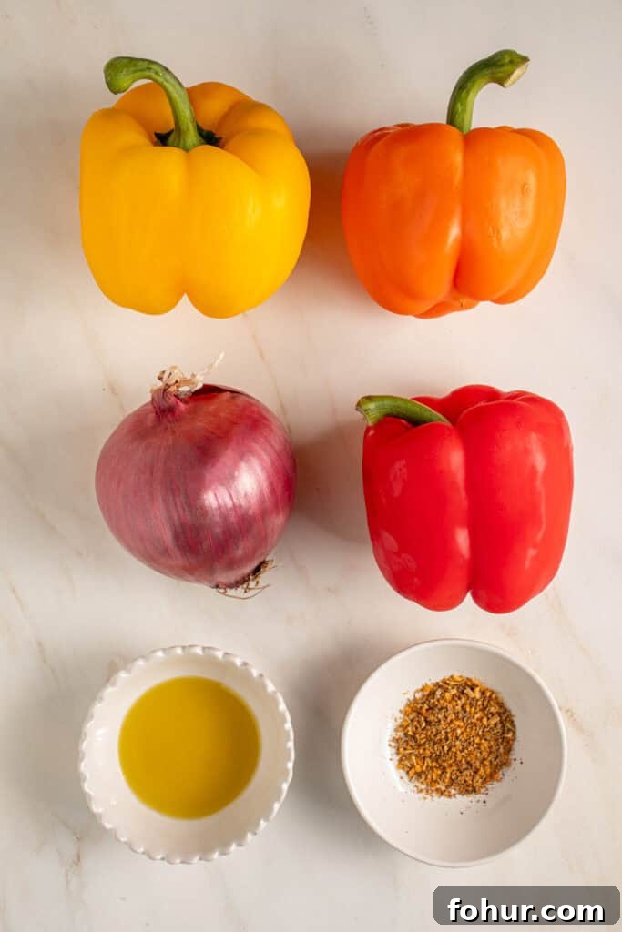 Grilled Peppers and Onions Recipe for Sides and Sandwiches 3 Ingredients for grilling peppers and onions laid out on a tabletop.