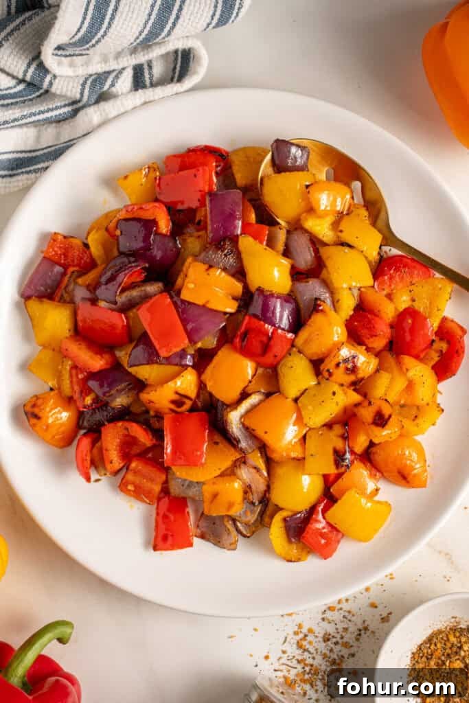 Grilled Peppers and Onions Recipe for Sides and Sandwiches 4 Colorful Grilled Peppers and Onions on a white plate.