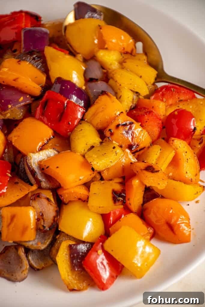 Grilled Peppers and Onions Recipe for Sides and Sandwiches 5 Colorful Grilled Peppers and Onions on a white plate.