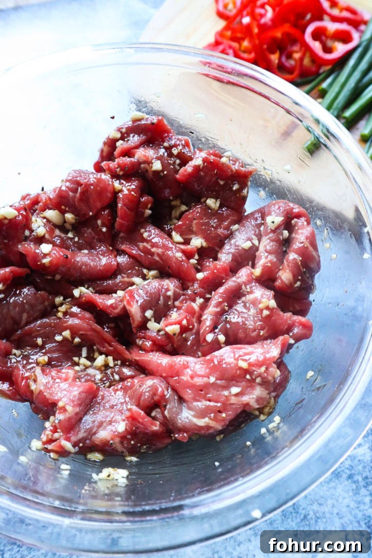 Pho Xao: Vietnamese Stir-Fried Beef and Rice Noodles 3 glass bowl with marinated sliced beef.
