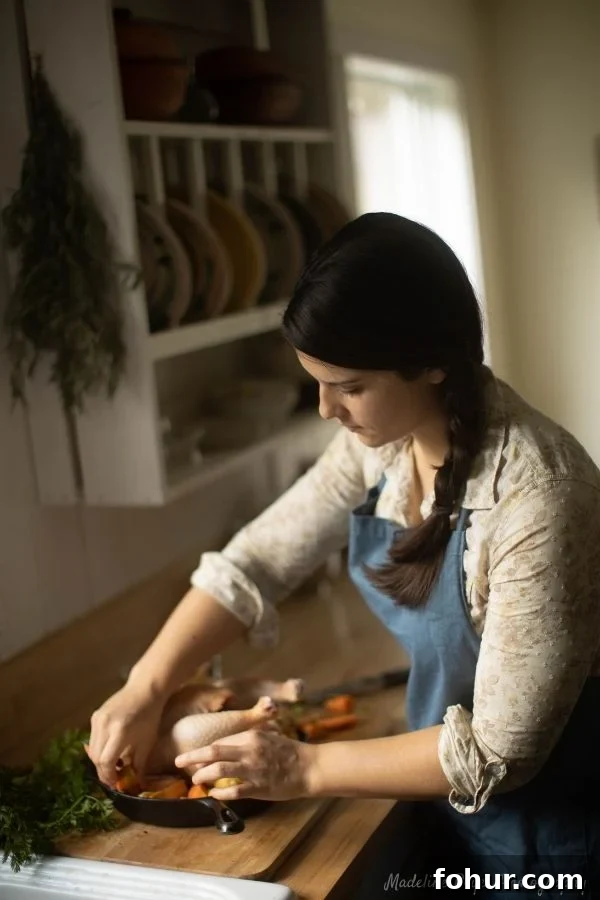 Autumn preparing a chicken at her kitchen counter