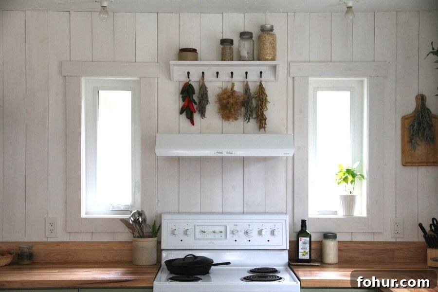 A white kitchen stove with wood countertops on either side
