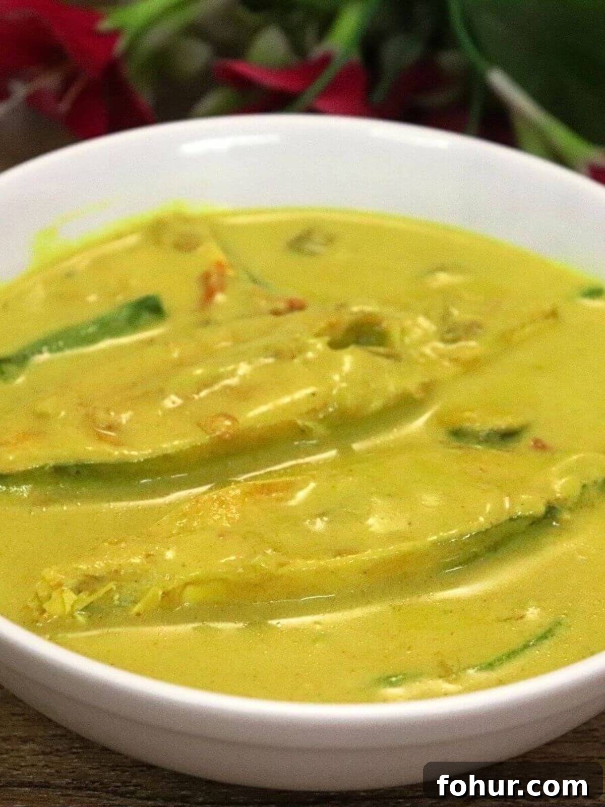 Authentic Goan Pomfret Caldine (Caldinho) Recipe 2 goan caldine curry made with pomfret fish, coconut milk and goan spices, served in a bowl.