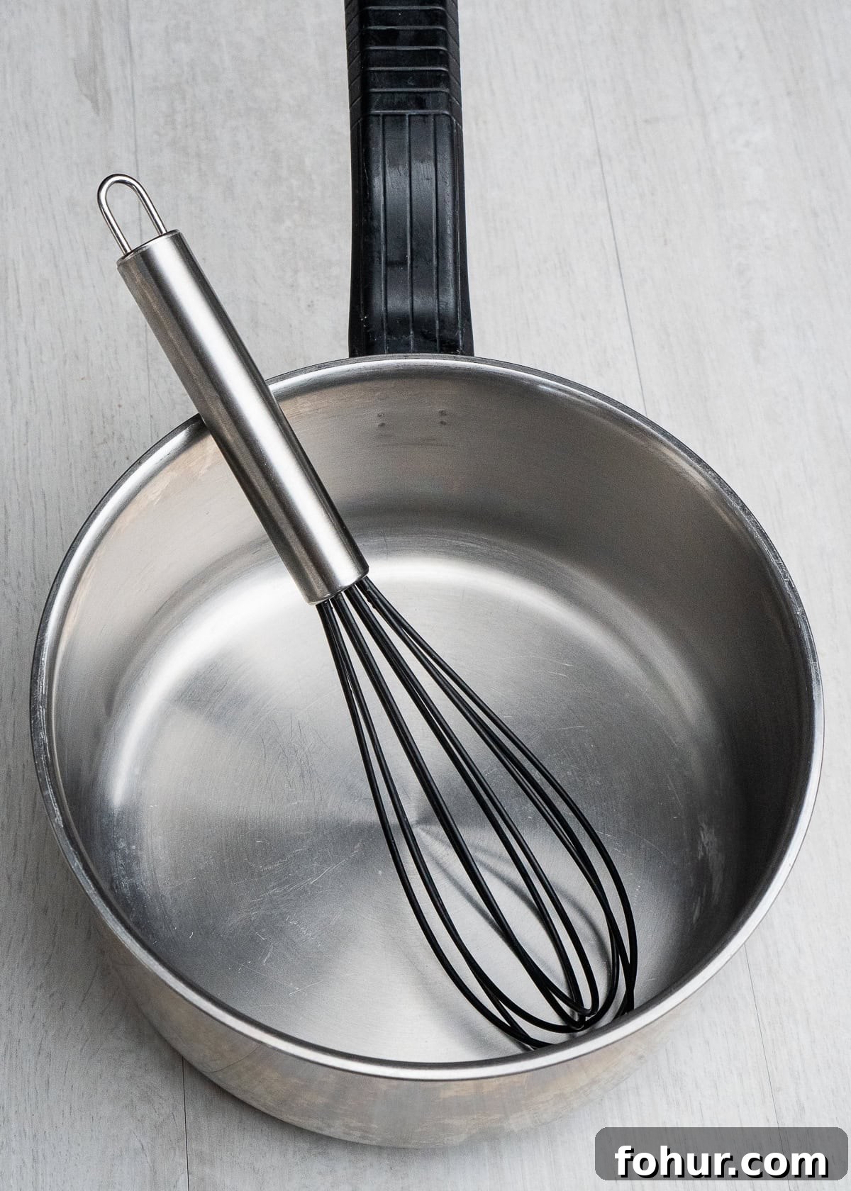 How to Make Salted Caramel Sauce 5 Saucepan with a whisk inside