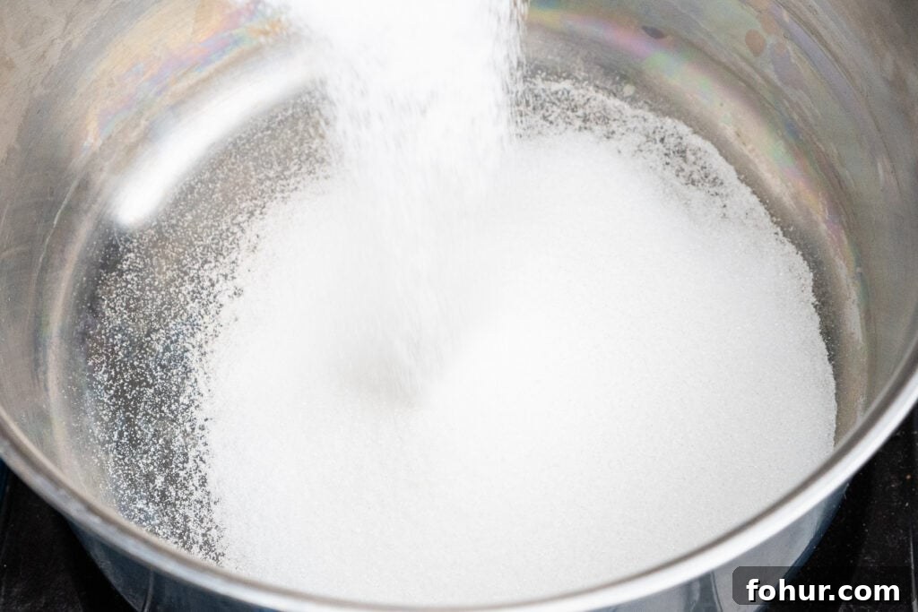 How to Make Salted Caramel Sauce 6 Pouring caster sugar into a heavy bottomed saucepan