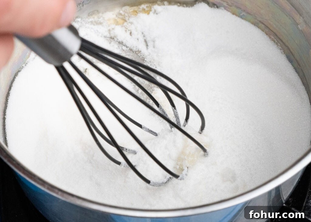 How to Make Salted Caramel Sauce 7 Stirring caster sugar in a saucepan using a whisk
