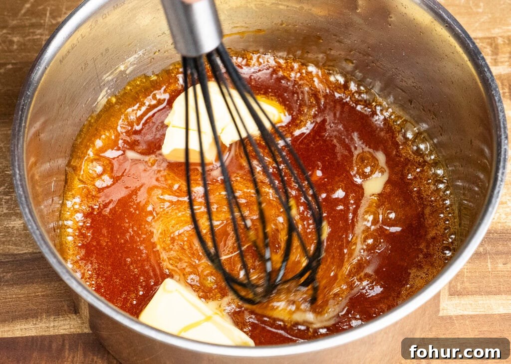 How to Make Salted Caramel Sauce 10 Butter added to melted sugar being whisked into caramel
