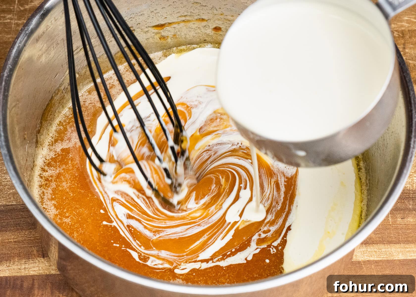 How to Make Salted Caramel Sauce 11 Pouring cream into melted sugar and butter to make caramel