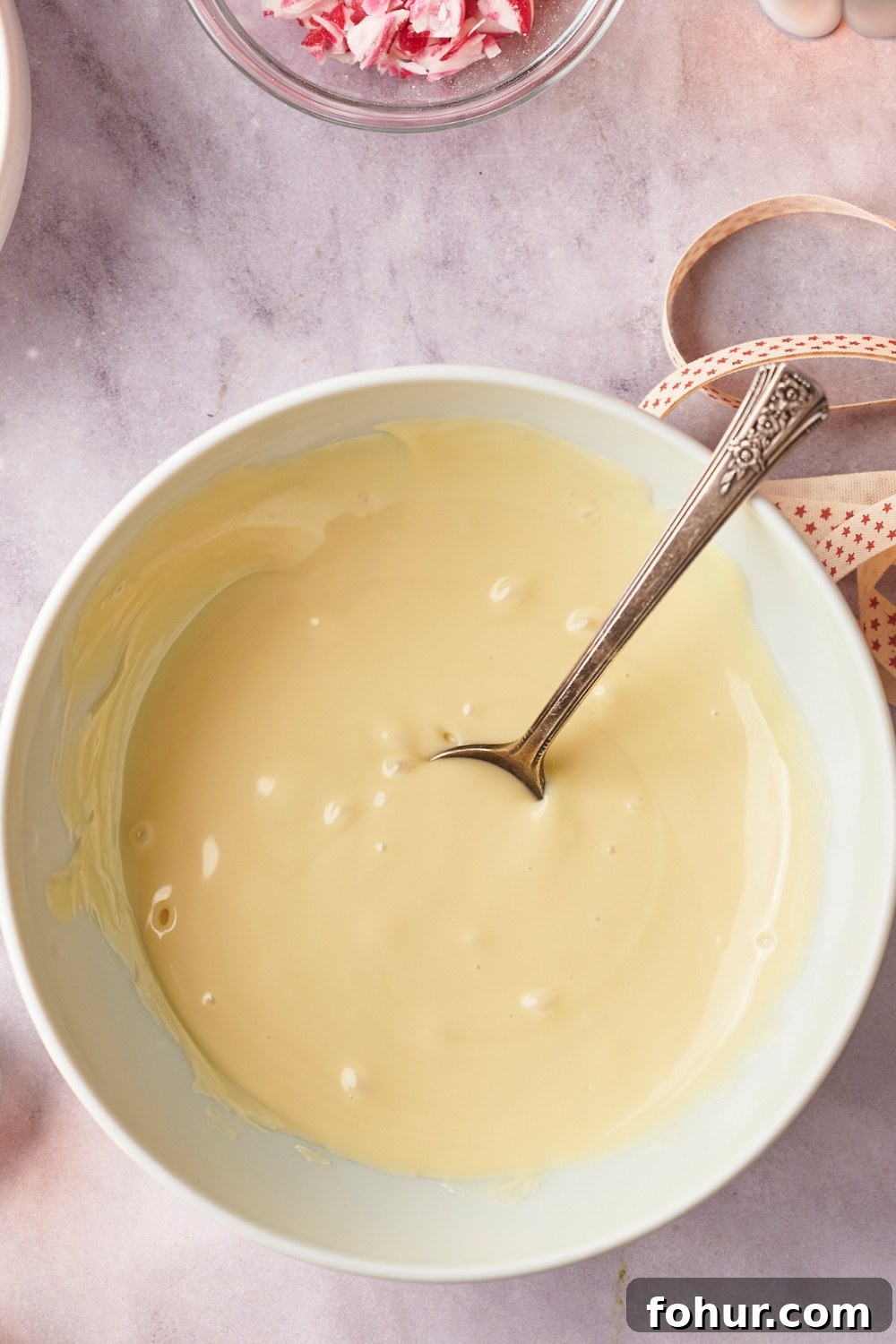 No-Bake Peppermint Bark Ready in 5 Minutes 6 A microwave-safe bowl with melted white chocolate.