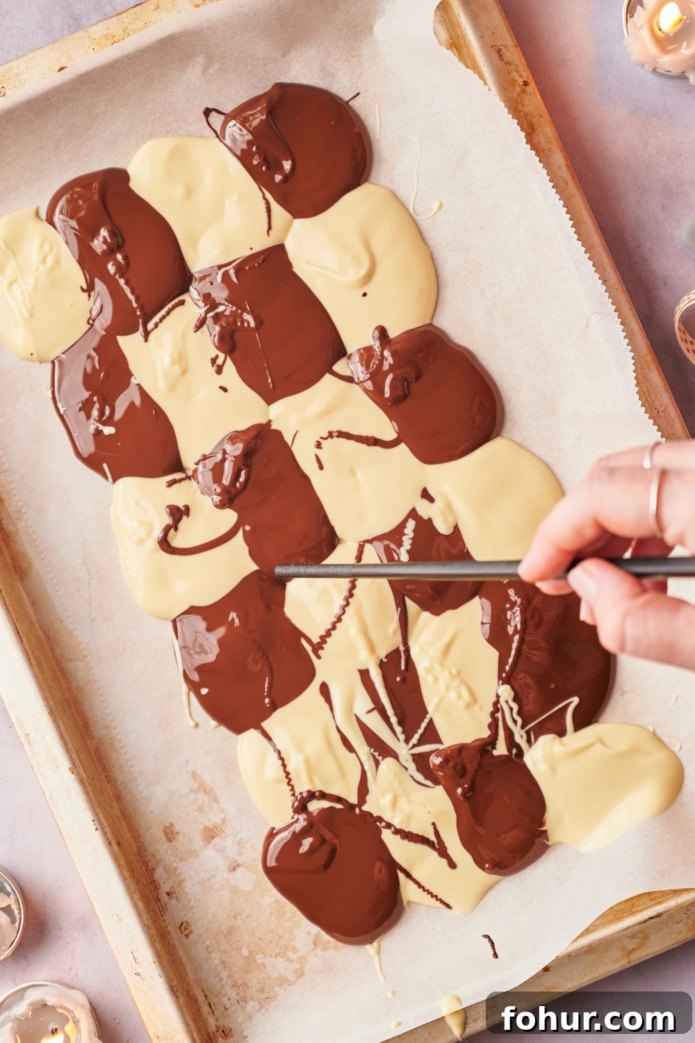 No-Bake Peppermint Bark Ready in 5 Minutes 7 Melted chocolate in a checkered pattern on parchment paper.
