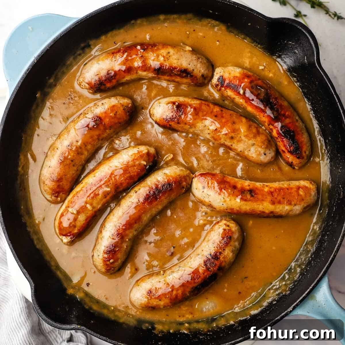 Classic British Bangers and Mash with Rich Onion Gravy 10 sausages and gravy in the pan