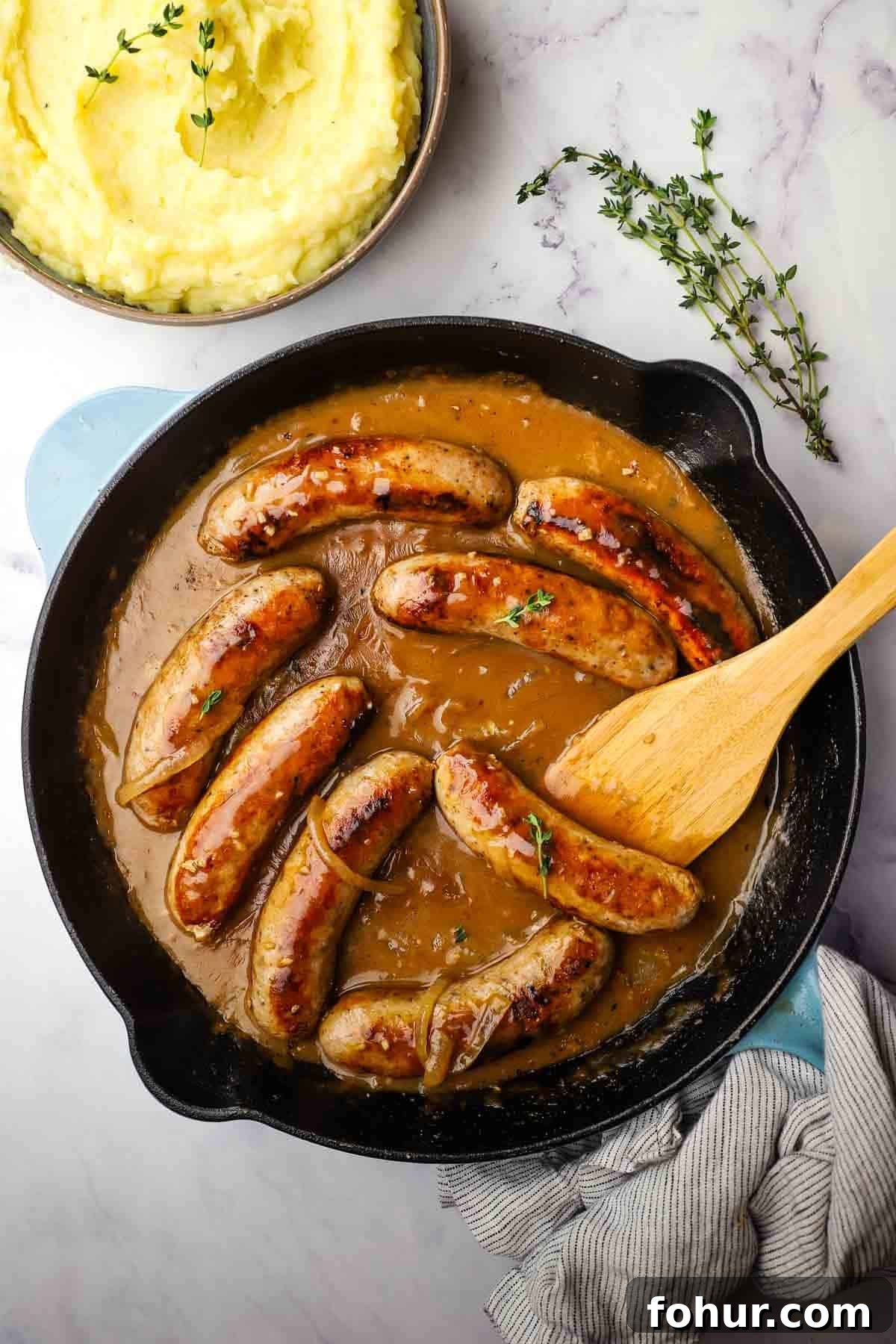 Classic British Bangers and Mash with Rich Onion Gravy 12 sausage and gravy in a skillet