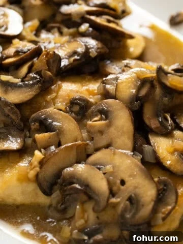Chicken marsala with mushrooms served over top.