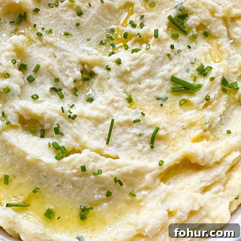 Creamy Rosemary and Roasted Garlic Mashed Potatoes 2 Rosemary Garlic Mashed Potatoes close up with butter.