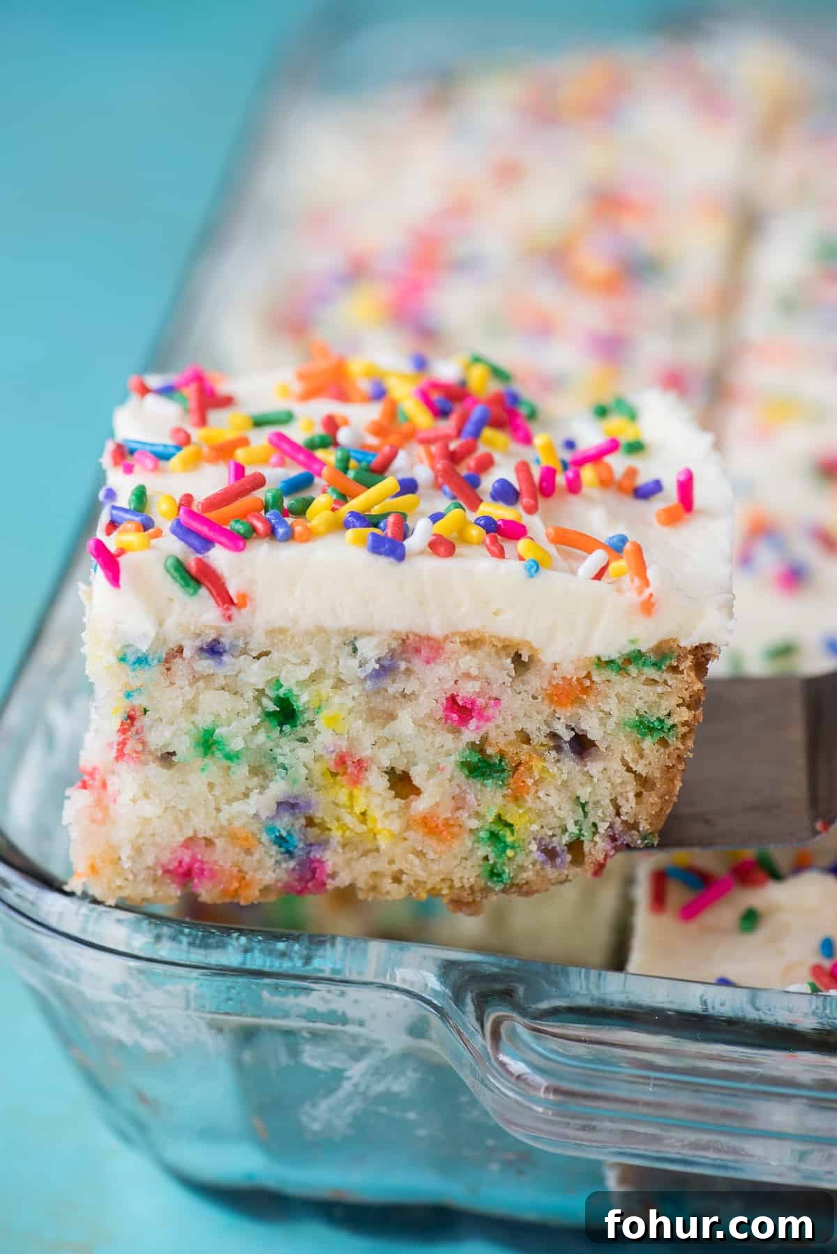 How to Make a Classic Funfetti Cake 3 piece of funfetti cake on metal spatula