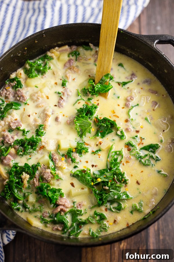Zuppa Toscana Recipe: Creamy Italian Sausage and Potato Soup 2 Large Dutch oven full of Zuppa Toscana with a wooden spoon in the middle