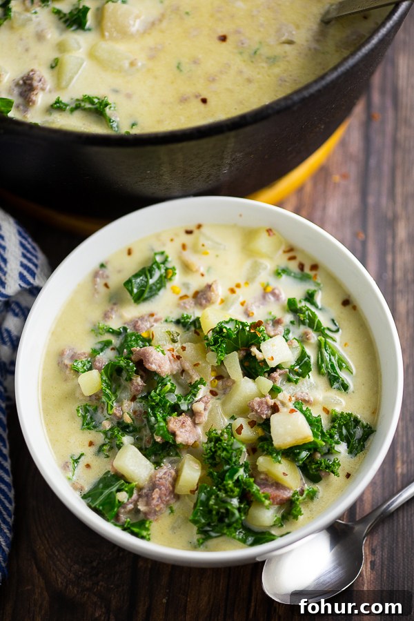 Zuppa Toscana Recipe: Creamy Italian Sausage and Potato Soup 3 Bowl full of Zuppa Toscana next to a spoon and large pot of soup
