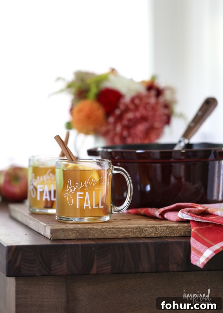 Apple Cider Mulled Wine served in mugs and in a large pot.