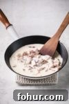 Creamy Low-Carb Keto Carbonara Pasta Recipe 9 bacon into cream in a pan