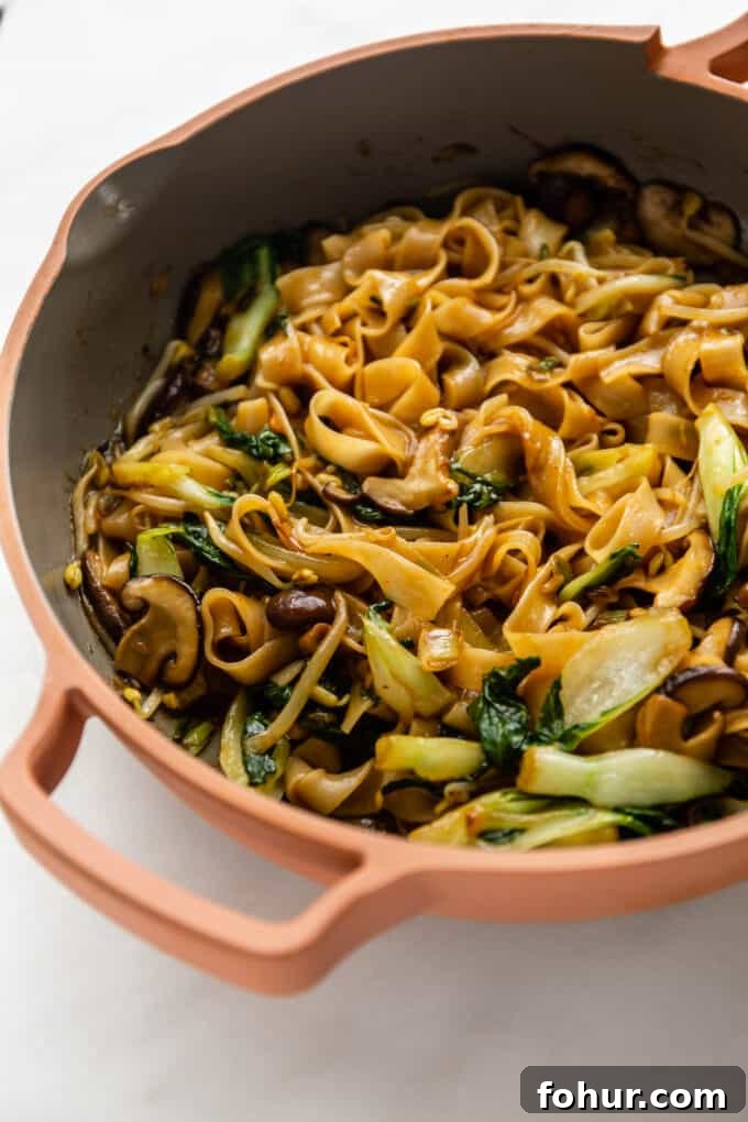 a pan of stir-fried ho fun noodles