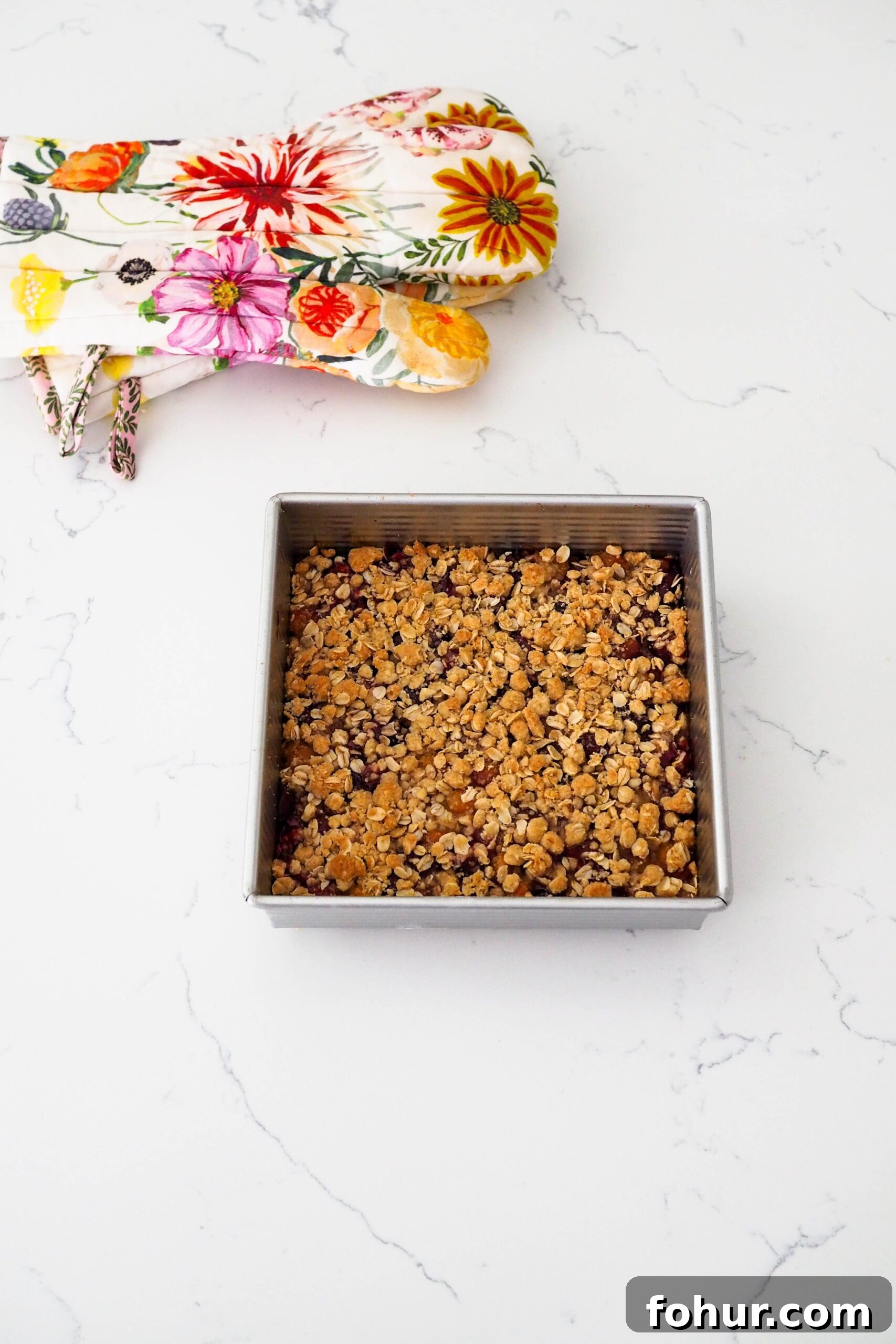 Cherry Crumble Bars with Buttery Oat Crust 11 A fully-baked cherry crumble on a quartz counter.